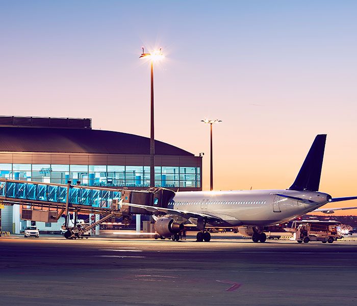 A plane on the runway at an airport.