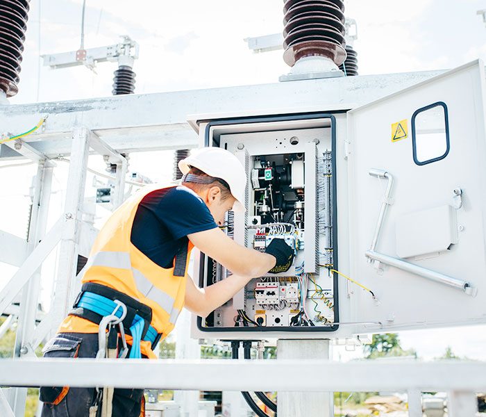 An electrician working on cabling.