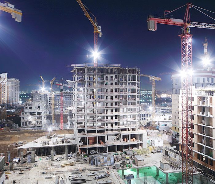 A construction site with cranes and buildings.